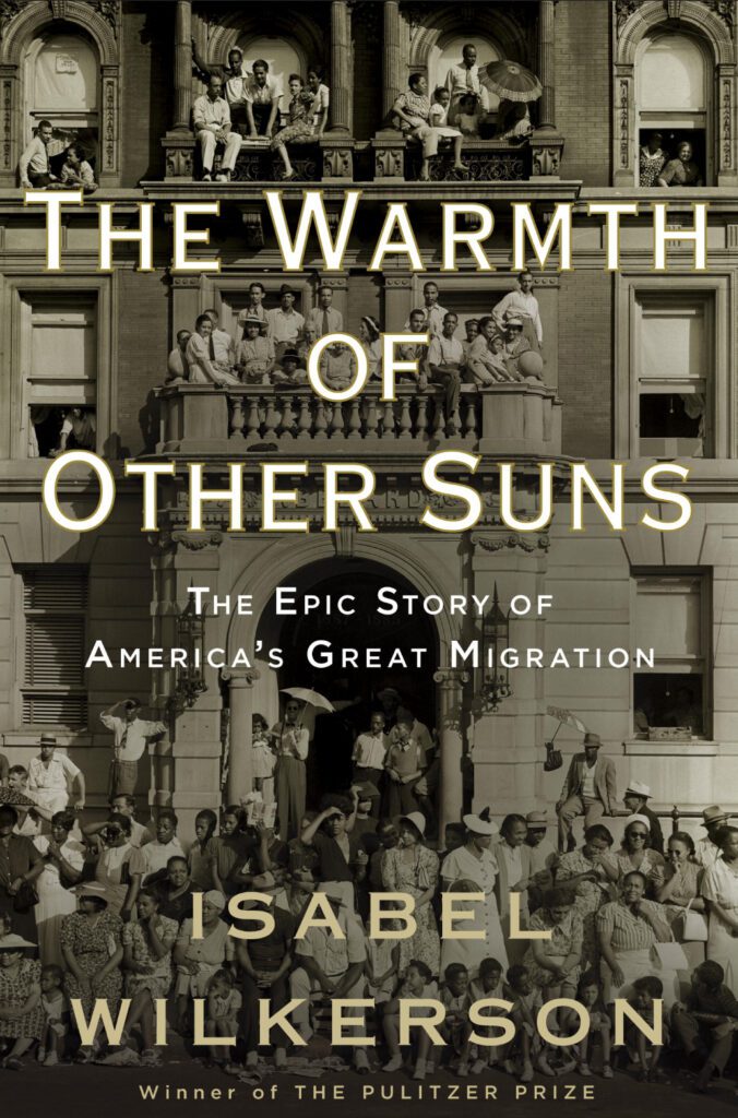 Book cover for “The Warmth of Other Suns” by Isabel Wilkerson, showing a sepia photo of a large group of people gathered on the steps and balcony of a building.
